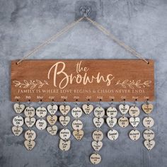 the browns family is where love begins and chaos ends wooden sign hanging on a wall