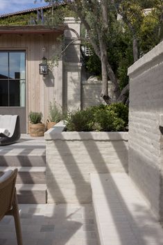 an outdoor patio with chairs and tables next to trees