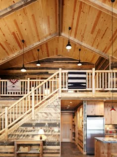 the inside of a log cabin with stairs