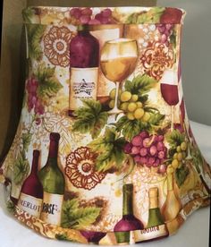 a lamp shade with wine bottles and grapes on it