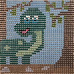 a cross - stitch picture of a green dinosaur in front of a tree with its mouth open