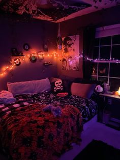 a bedroom decorated for halloween with purple lights and skulls on the wall, bedding