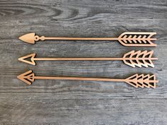 three wooden arrows on a wood table