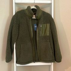 Brand New With Tags. Olive Green Sherpa Jacket With Faux Leather Trim And Chest Pocket. Size Medium. Khaki Fleece Outerwear For Winter, Khaki Outerwear With Fleece Lining For Fall, Green Fleece Jacket For Winter, Fleece Outerwear For Fall, Fleece Outerwear For Work In Fall, Fleece Outerwear For Fall Workwear, Khaki Fleece Outerwear For Fall, Green Fleece Outerwear For Winter, Green Fleece Outerwear For Cold Weather