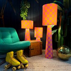 two yellow roller skates sitting next to a green chair and lamp in a room