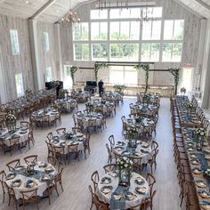 a large banquet hall with tables and chairs set up for an event or wedding reception