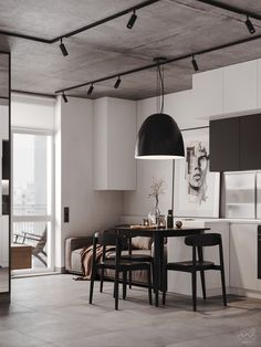 an open kitchen and dining area with black chairs