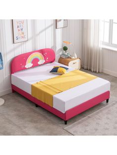 a child's bed with pink, yellow and white sheets