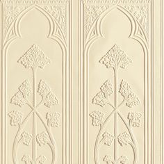 an intricately designed paneled wall with flowers and leaves on the side, in cream