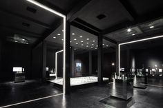 an empty room with mirrors and lights on the walls, in black and white colors