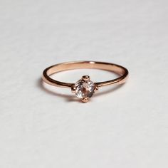 a gold ring with an oval shaped diamond