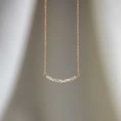 Six 0.02ct. baguette diamonds (SI clarity) Two 1mm round white diamonds (SI clarity, G+ color) The diamonds are arranged as a series of “dashes” and “dots” that spell “M-A-M-A” in Morse Code! Solid 14k gold (or platinum) rope chain and lobster clasp. Total length is 18" with two shortening stations, one at 17" and one at 16". Signature Melanie Casey lab-grown diamond drop on the chain. We handcraft each piece with responsibly sourced metals and ethically sourced stones. Find out more about Diamo Gold Sterling Silver Necklaces With Baguette Diamonds, Gold Sterling Silver Necklace With Baguette Diamonds, Timeless Diamond Necklace With Baguette Diamonds As A Gift, Delicate Baguette Diamond Jewelry For Everyday, Minimalist Baguette Cut Diamond Necklace For Anniversary, Minimalist Everyday Baguette Jewelry, Timeless Baguette Jewelry As Gift, Delicate Everyday Jewelry With Baguette Diamonds, Dainty Baguette Jewelry For Everyday