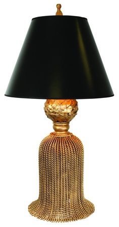 a table lamp with a black shade on it's base and gold trimmings