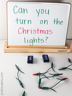 christmas lights are laid out in front of a sign that says can you turn on the christmas lights?