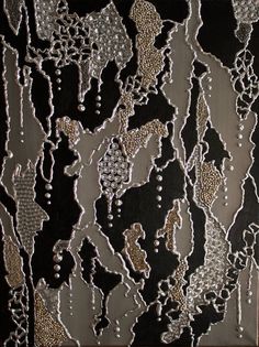 an abstract painting with black and gold colors on the surface, including small white dots