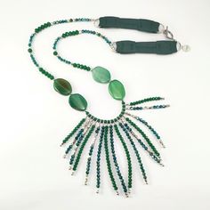 One of a kind long green statement necklace handcrafted with rondel and bicone crystals, silver plated metal beads, green agates and leather. The toggle clasp is stainless steel and it's made with stringing steel cable. It's perfect to highlight your outfit, basic or sophisticated. ❤GIFT WRAPPING: Each product is well packed in a gift bag and box too. ❤IMPORTANT TO KNOW: This piece is one of a kind, that it means, that isn't another piece like that. This is what I love to do: unique pieces for e Adjustable Green Crystal Necklaces With Gemstone Beads, Adjustable Green Gemstone Beads Crystal Necklaces, Elegant Green Beaded Long Crystal Necklace, Adjustable Green Crystal Necklace With Beaded Chain, Adjustable Green Beads Long Necklace, Green Beaded Long Crystal Necklace, Long Green Beaded Crystal Necklace, Green Beaded Agate Crystal Necklace, Luxury Green Statement Beaded Necklaces