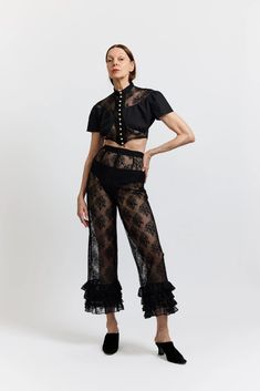 Details High-waisted cropped pants in sheer black lace with four layers of ruffles at the hem. Side zipper closure Worn with the Ashlyn Blouse Content + Care 100% Polyester Dry Clean Only Made in NYC Fit Fits true to size Birgitt is 5'11" and wears a size 2 Size 2 Measurements: Bust - 27" Waist - 41" Size 10 Measuremen Lace Pants Outfit, High Waisted Cropped Pants, 2024 Wardrobe, Casual Academia, Nyc Fits, Black Cotton Fabric, Basic White Tee, Floral Print Pants, Lace Pants