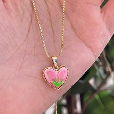 Trendy Pink tulip flower heart shaped pendant charm necklace, 14K real gold plated chain. Crafted from high-quality materials, this stunning necklace features a delicate heart-shaped pendant adorned with a beautiful pink tulip motif, symbolizing love, beauty, and new beginnings. Cute girly aesthetic, y2k layering necklace choker. Exquisite statement necklace to elevate your fashion style. 💎 Features: ♥ Handmade jewelry ♥ Finish Tone: Finest 14K gold plated | Pink ♥ Approximate Measurements: - L Cute Heart Pendant Necklace, Cute Heart Pendant Necklace With Clavicle Chain, Valentine's Day Flower Shape Clavicle Necklace, Pink Heart Pendant Charm Necklace, Pink Heart Pendant Charm Necklace With Clavicle Chain, Pink Flower Pendant Necklace For Valentine's Day, Pink Heart Pendant Charm Necklace On Clavicle-length Chain, Pink Clavicle Chain Necklace For Valentine's Day, Dainty Pink Charm Necklace With Adjustable Chain