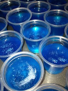 blue cups filled with liquid sitting on top of a table