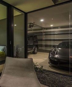 a car is parked in the garage next to a bed