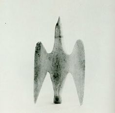 a black and white photo of an object in the snow with two wings on it