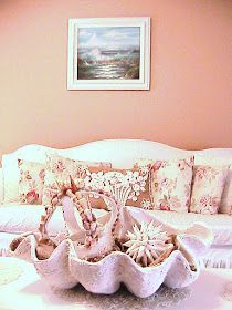 a living room filled with lots of furniture and pillows on top of a white couch