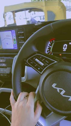 a person is driving a car with their hands on the steering wheel