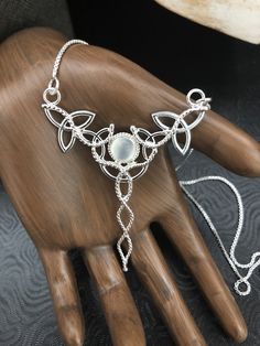 "I've fabricated a Celtic Knot inspired, statement necklace to which is perfect for a wedding, or hand fasting, or even a Renaissance event, with sterling silver Trinity Knots woven into a necklace and featuring an 8mm glowing genuine White Moonstone, or your choice from the drop down menu. The motif of the pendant is designed with a total of 5 Trinity Knots and sterling wire work braids down the center to add the balancing touches to the piece. It comes with a 16 inch sterling silver box chain Work Braids, Celtic Necklace For Women, Torc Necklace Celtic, Triple Moon Goddess Necklace, Celtic Jewellery Ancient, Celtic Knot Wedding, Necklaces Wedding, Wedding Knot, Hand Fasting