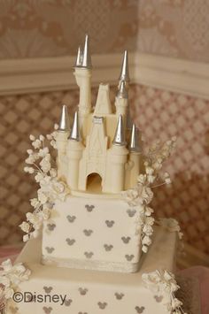 a wedding cake with a castle on top