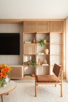 a living room filled with furniture and a flat screen tv mounted on a wall next to a window