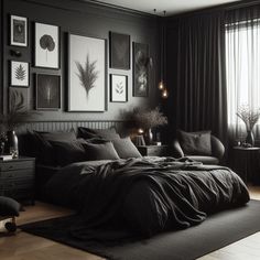 a bedroom with black walls and pictures on the wall above the bed, along with other furniture