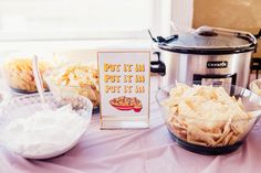 a table topped with bowls filled with chips