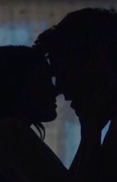 the silhouette of two people kissing each other