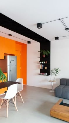 an orange and white living room with modern furniture