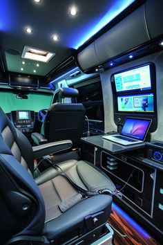 the interior of a vehicle with many electronic devices on it's desks and seats