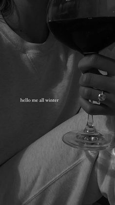 a woman holding a wine glass with the words hello me all winter written on it