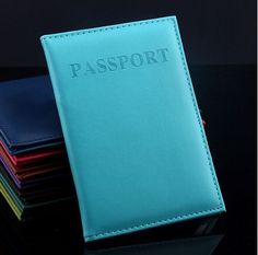 a stack of passport covers sitting on top of each other in front of a black background