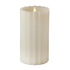 a white pillar candle with a lit candle in the middle