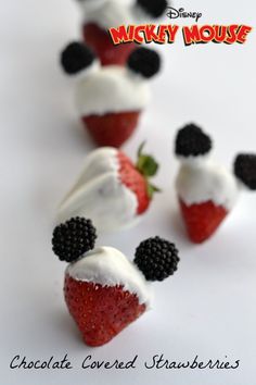 mickey mouse strawberries are topped with whipped cream and blackberries