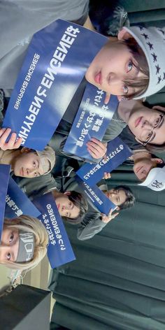 a group of young people holding up signs