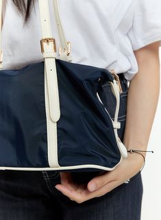 Product Detail Style : Casual Detail : Buckle Outer Shell Polyester 80 Polyurethane 20 / Lining Polyester 100 Color : Dark blue, Black, Beige Model Size Model is wearing size One Size and the color Dark blue. Height : 5'5" | 165cm / Top : S / Bottom : S (26 inch) .prddescription table, .prddescription td, .prddescription th { border : 1px solid black; border-collapse : collapse; padding: 10px; } Size(Inch) Size Width Height Depth String Height One Size 12.6" 8.3" 5.7" 10.8" - The measurement can Blue Nylon Shoulder Bag With Detachable Strap, Navy Nylon Bags With Adjustable Strap, Blue Nylon Shoulder Bag With Adjustable Strap, Blue Nylon Shoulder Bag With Double Handle, Blue Nylon Shoulder Bag With Zipper, Trendy Blue Nylon Shoulder Bag, Large Capacity Navy Shoulder Bag, Blue Versatile Satchel With Zipper Closure, Versatile Blue Satchel With Zipper Closure