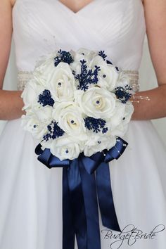 a bridal holding a bouquet of white and blue flowers