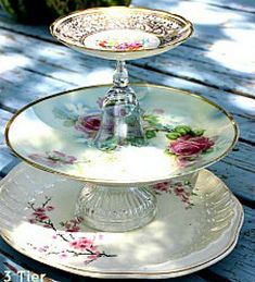 three tiered plate serving dish sitting on top of a wooden table