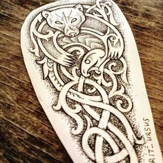 an intricate tattoo design on a wooden table