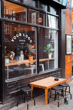 two wooden tables sitting outside of a coffee shop