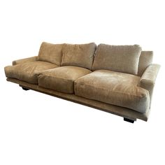 a brown couch sitting on top of a white floor