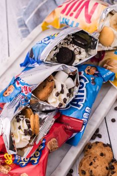 two bags of cookies and ice cream sitting next to each other on top of a table