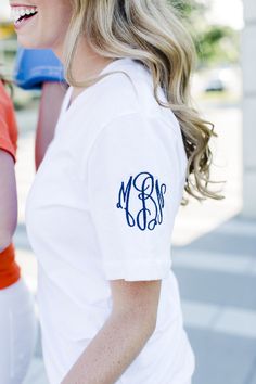 a woman wearing a monogrammed polo shirt