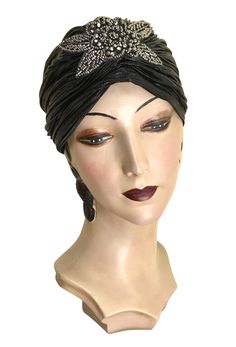 Made of a luxurious stretch black lamé with a beautiful vintage beaded appliqué. One size fits all. Black Vintage Headband For Evening, Black Fitted Headband For Evening, Fitted Black Headband For Evening, Embellished Adjustable Headpieces For Evening, Fitted Black Headpiece For Vintage Events, Traditional Fitted Turban For Party, Vintage Black Headband For Party, Black Flapper Headpieces For Vintage Events, Black Fitted Gatsby Headpiece