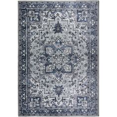 a blue and white rug with an intricate design on the middle, in front of a white background